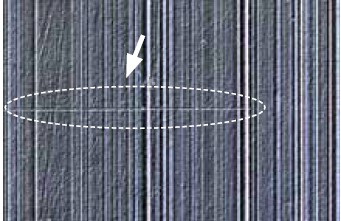 A stylus was dragged across this sample's surface, leaving a linear mark.