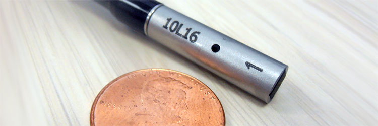 Custom probe next to a penny