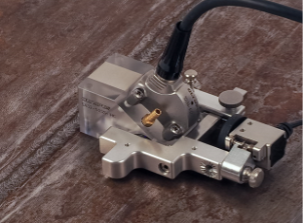 Universal holder assembled with a phased array probe and wedge and the Mini-Wheel wheel encoder
